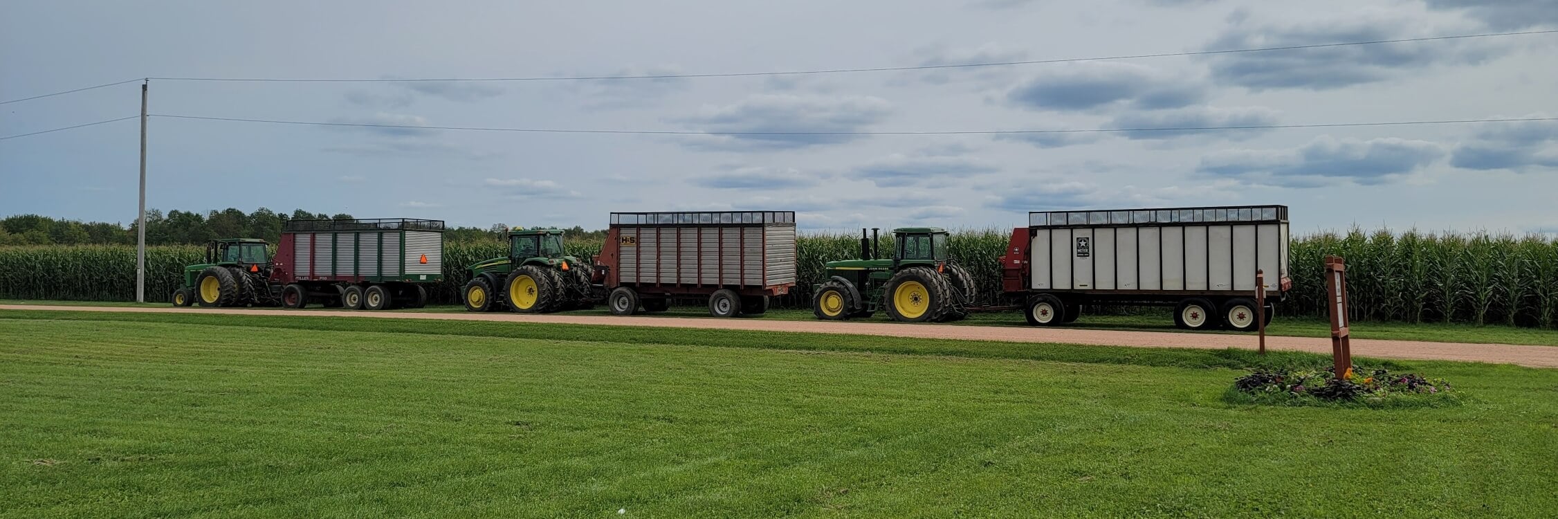 John Deere Tractors Pulling Hay Wagons/Carts