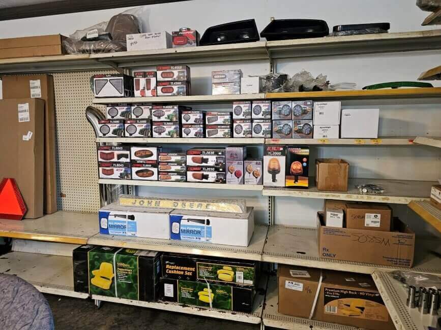 Ulrich Equipment Parts Department shelf with tractor lights and seats