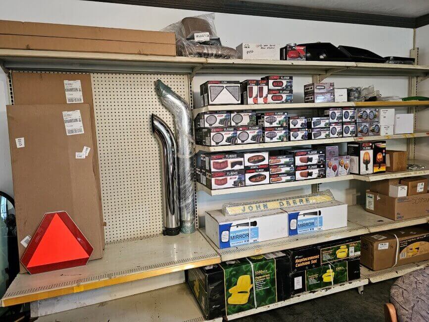 Ulrich Equipment Parts Department shelf with tractor parts and exhaust stacks