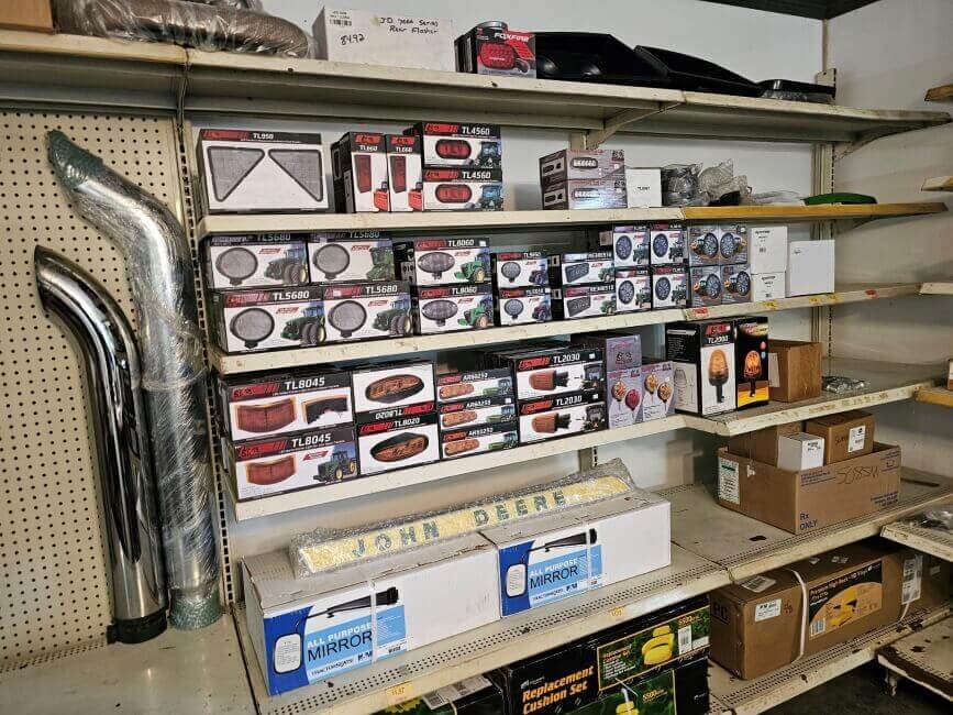 Ulrich Equipment Parts Department shelf with tractor lights and mirrors